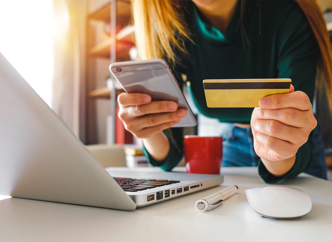 Pay Bill - Woman Using Her Credit Card to Pay an Insurance Bill