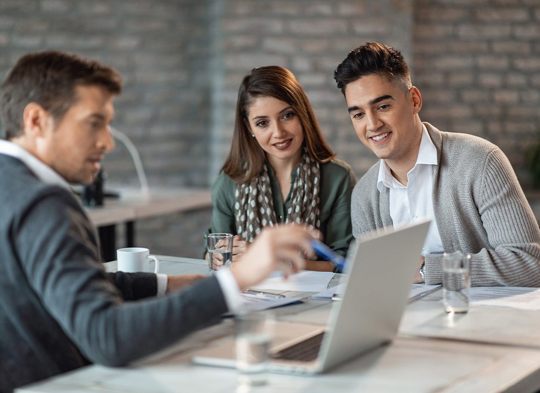 About Our Agency - Insurance Agent Reviewing Coverage with a Young Couple